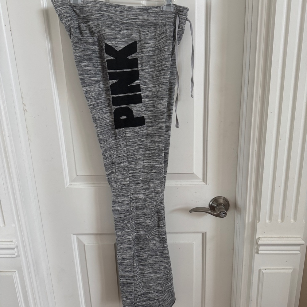 PINK jogger pants. Black and white with emblems. Medium